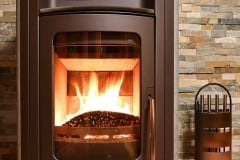 Wood burning stove in front of stonewall
